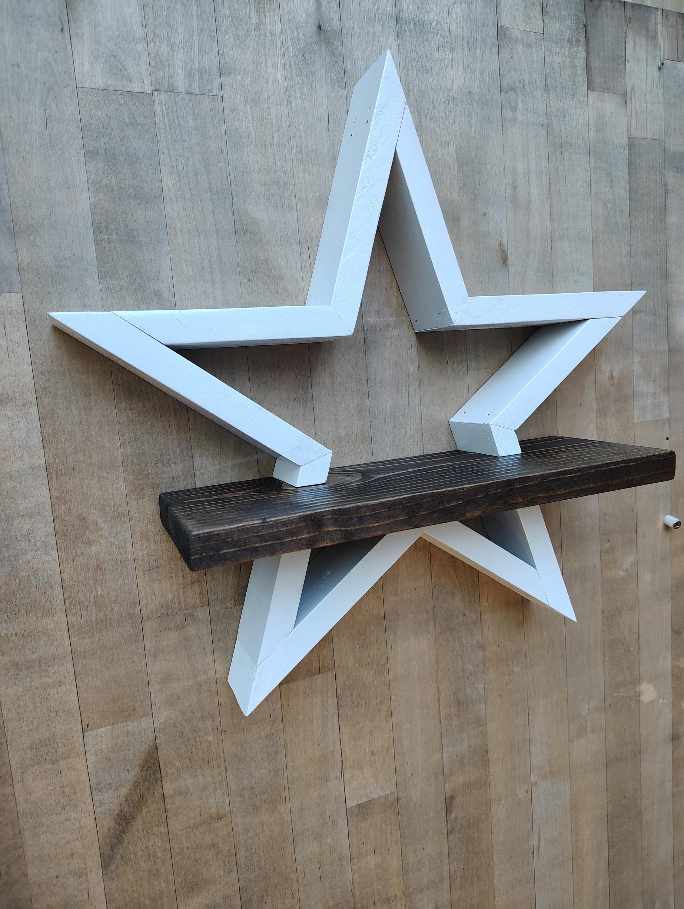 Rustic wooden star wall shelf hanging on wall