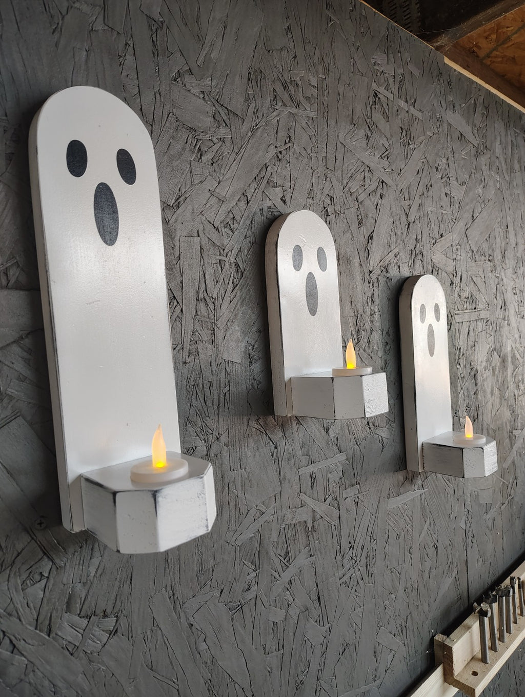 Handmade Halloween ghost candle holders displayed with candles