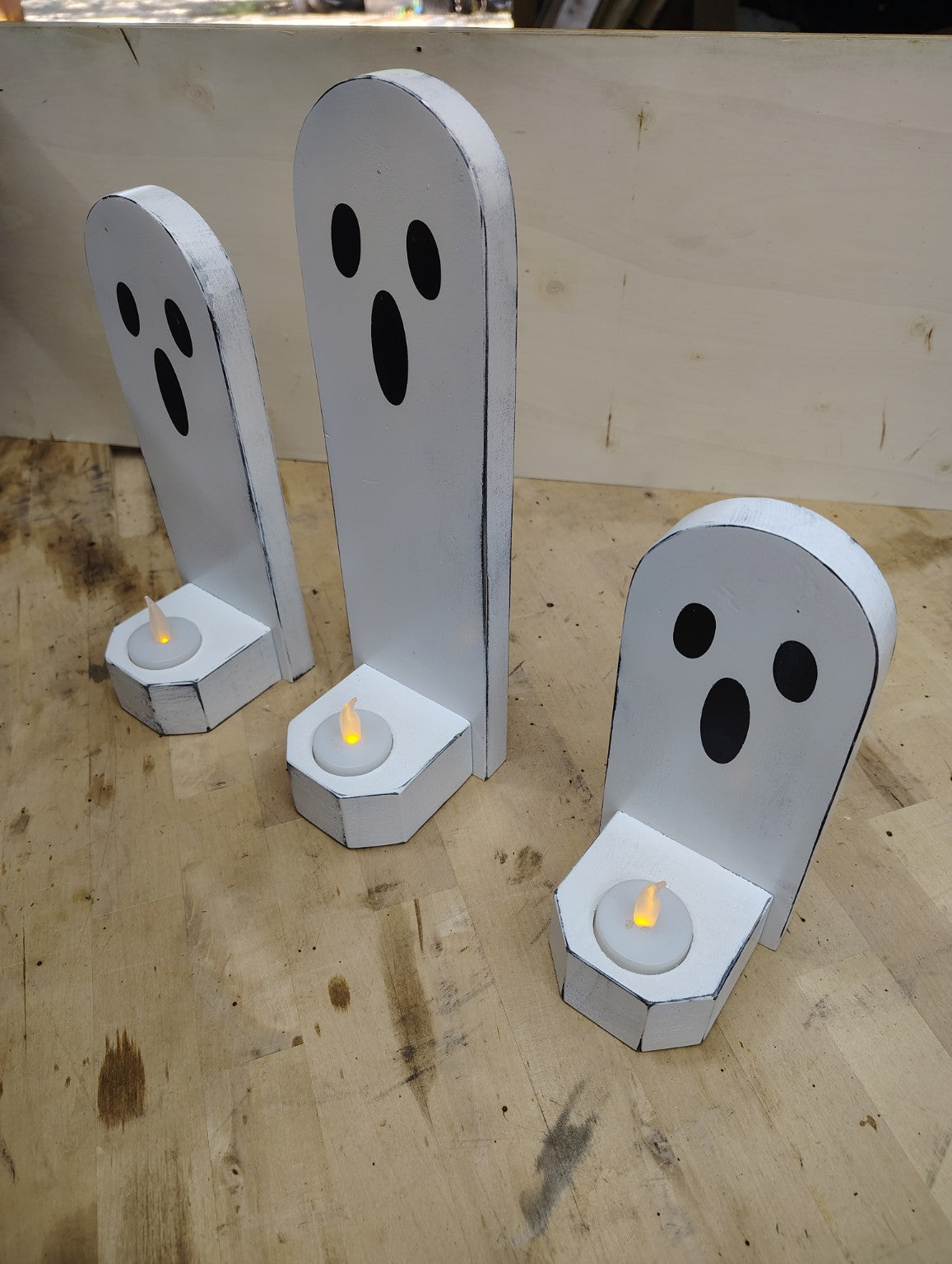 Three rustic wooden Halloween ghost candle holders