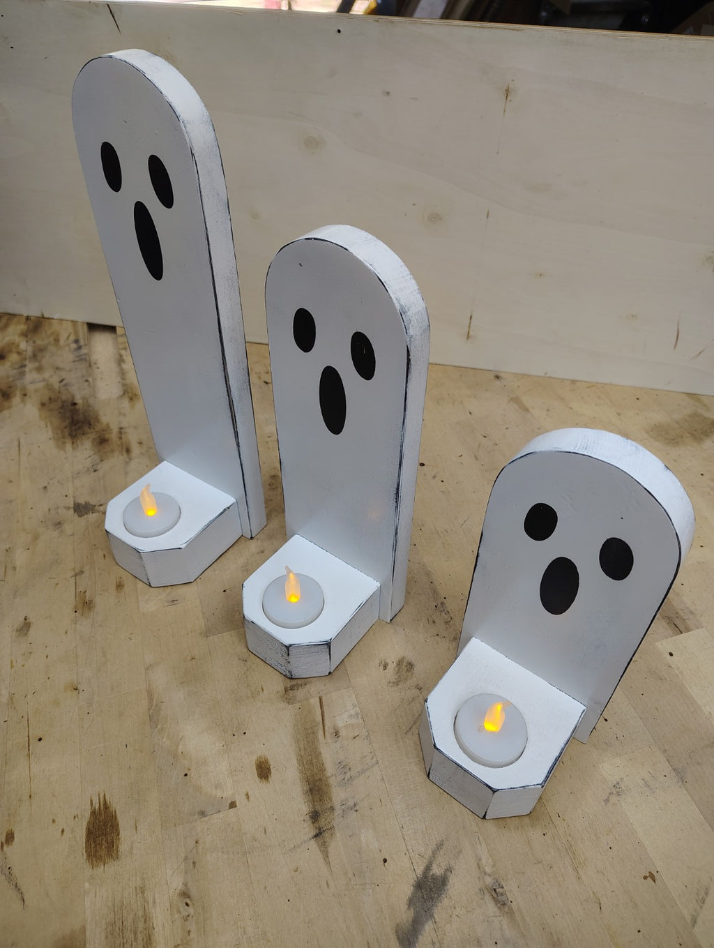Wooden ghost candle holder set displayed together