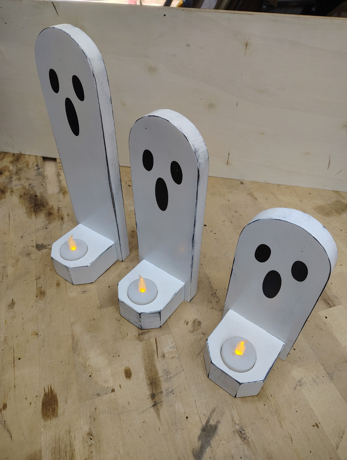 Wooden ghost candle holder set displayed together